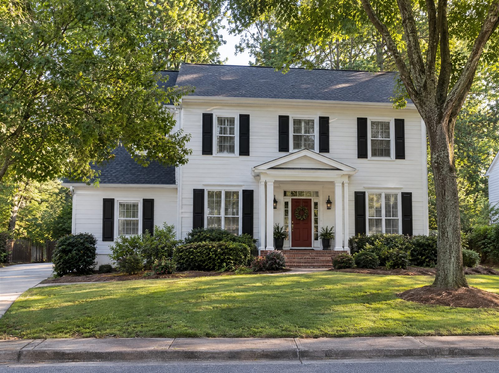 Same house painted white with black shutters