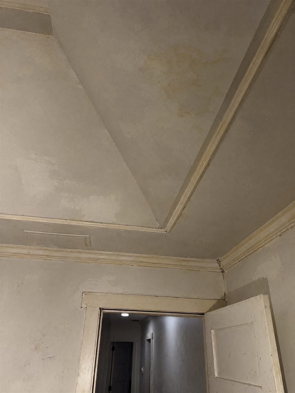 Tray ceiling with stains and yellowed trim before painting